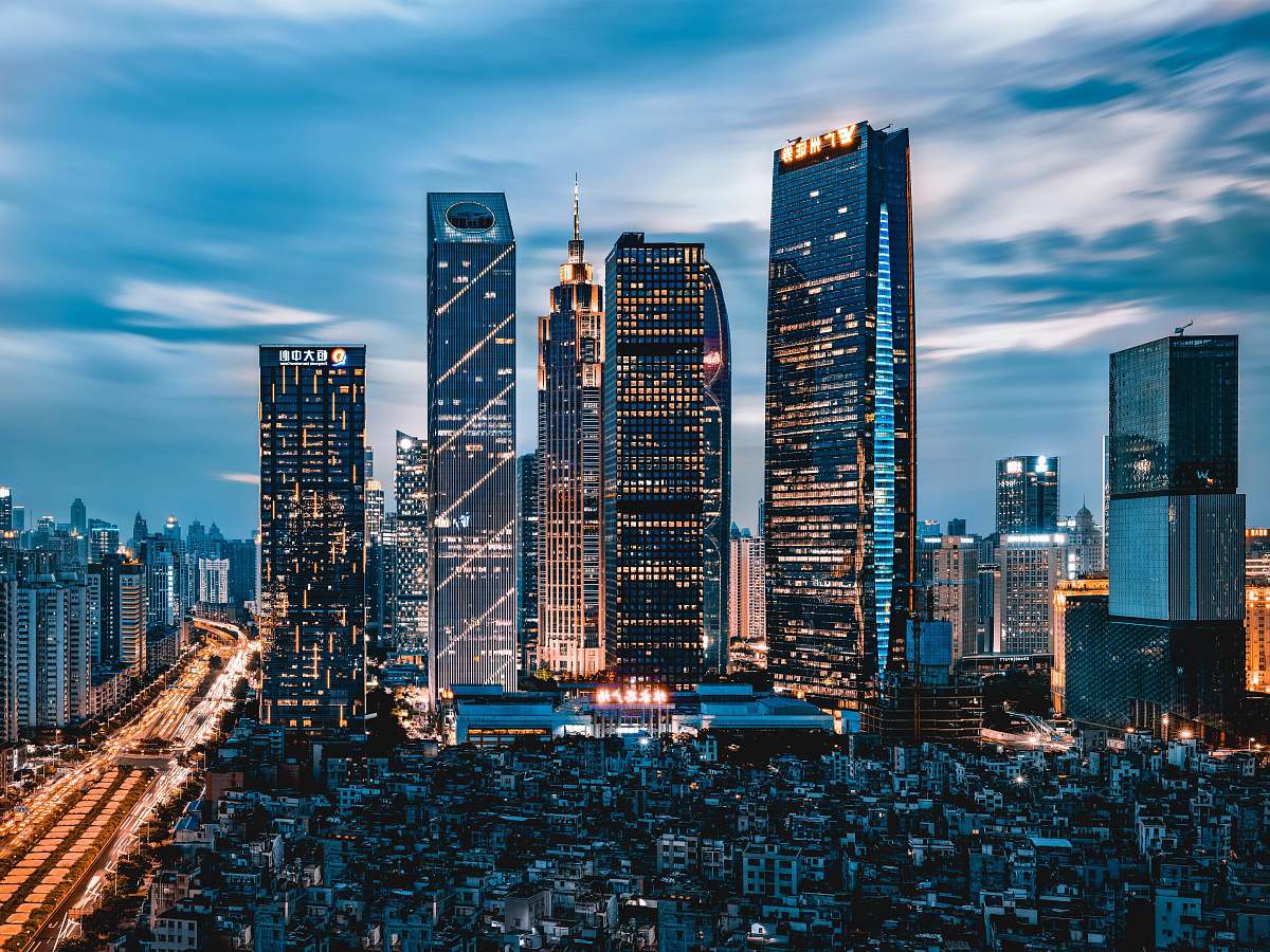 high rise grey clouds hovering over city lights town